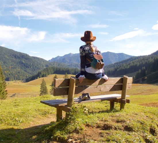 A Day In The Mountains. Fashion Blogger Girl by Style Blog Heartfelt Hunt. Girl with blond braid wearing a norwegian sweater, blouse with trumpet sleeves, destroyed denim jeans, hat, Ray-Ban sunglasses, backpack and Converse sneakers.