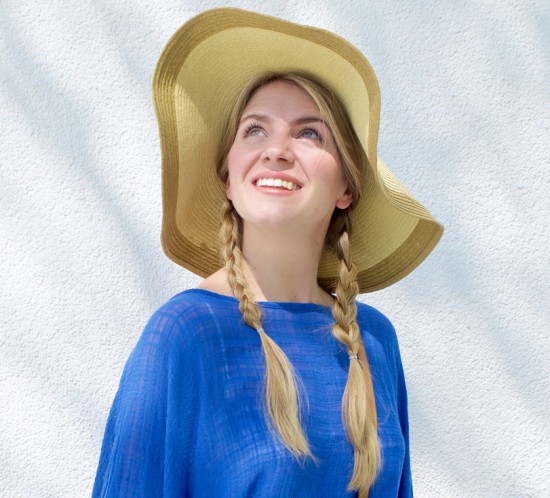 Blue Tassels. Fashion Blogger Girl by Style Blog Heartfelt Hunt. Girl with two braids wearing a top with blue tassels and a straw hat.