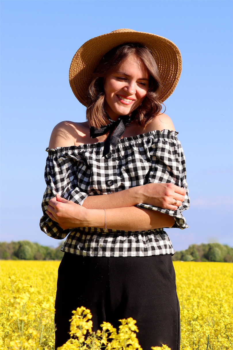 Canola Love. Fashion Blogger Girl by Style Blog Heartfelt Hunt. Girl with blond beach waves wearing an off-shoulder gingham blouse, black culotte, straw hat and straw bag.