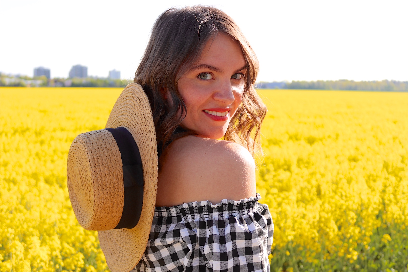 Canola Love. Fashion Blogger Girl by Style Blog Heartfelt Hunt. Girl with blond beach waves wearing an off-shoulder gingham blouse, black culotte, straw hat and straw bag.