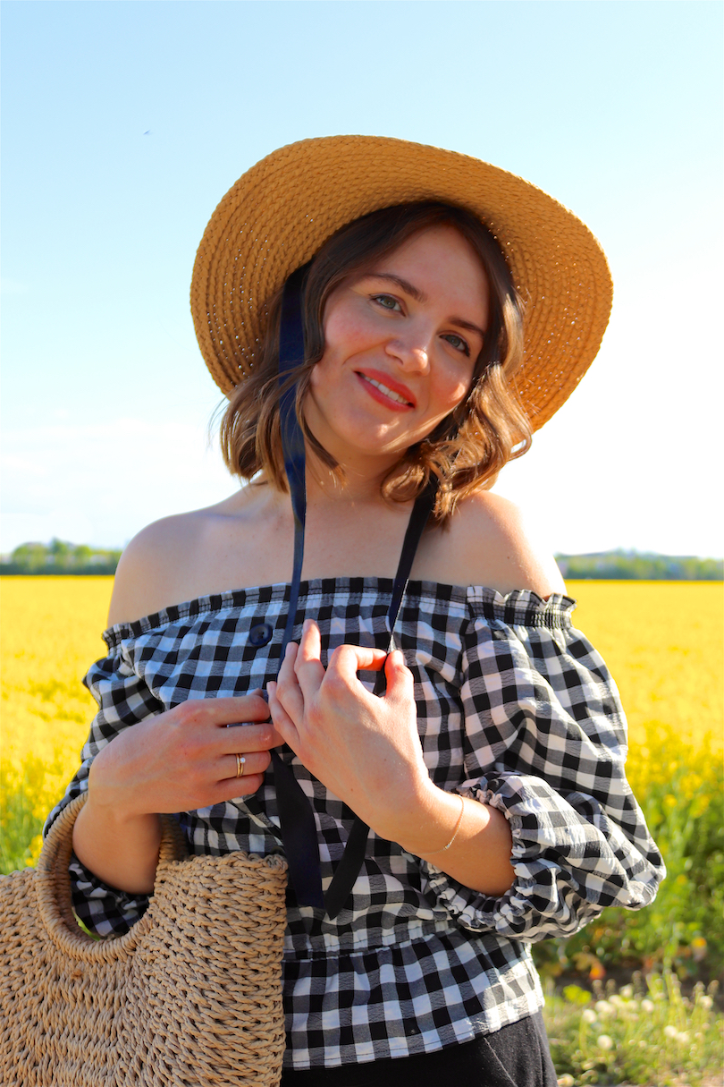 Canola Love. Fashion Blogger Girl by Style Blog Heartfelt Hunt. Girl with blond beach waves wearing an off-shoulder gingham blouse, black culotte, straw hat and straw bag.