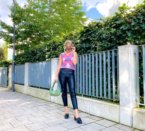 Check Vest. Fashion Blogger Girl by Style Blog Heartfelt Hunt. Girl with blond hair wearing a check vest, faux leather pants, green sunglasses, green ruched bag and loafers.