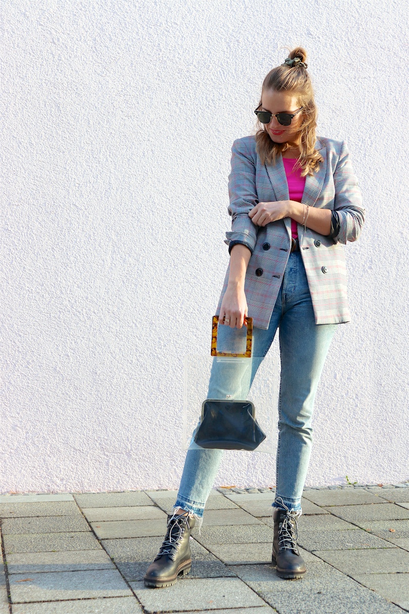 Checked Pink. Fashion and Style Blog Girl from Heartfelt Hunt. Girl with blonde hair and scrunchie wearing a checked blazer, pink top, mom jeans, green earrings, green sunglasses, transparent bag, belt and Timberland boots.