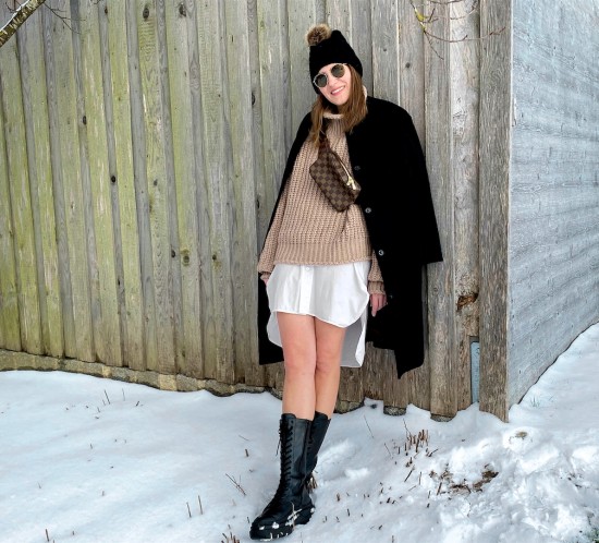 Combat Boots. Fashion Blogger Girl by Style Blog Heartfelt Hunt. Girl with blond hair wearing a black coat, turtleneck sweater, long blouse, pompom beanie, Louis Vuitton belt bag and combat boots.