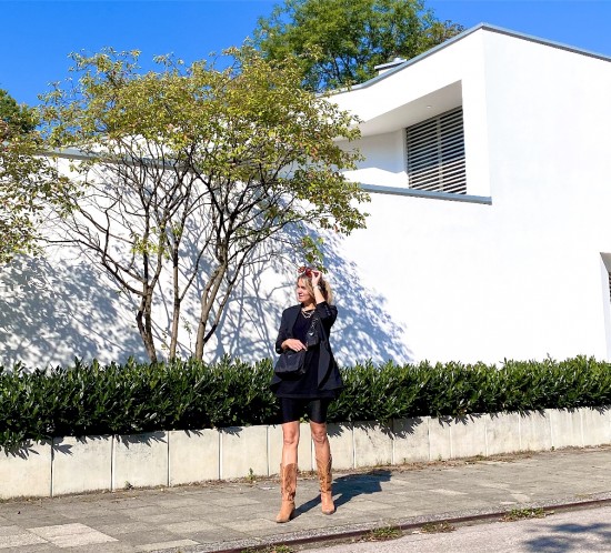 Cowboy Boots. Fashion Blogger Girl by Style Blog Heartfelt Hunt. Girl with blond hair wearing cowboy boots, blazer, black top, legging shorts, orange sunglasses and 90s bag.