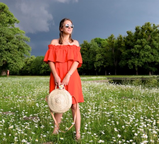 Daisy Meadow. Fashion Blogger Girl by Style Blog Heartfelt Hunt. Girl with blond hair wearing an orange off shoulder dress, Ray-Ban sunglasses, straw bag and leopard sandals.