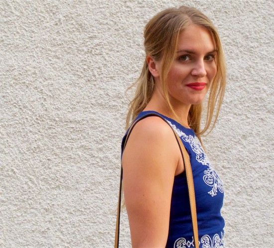 Denim Flares. Fashion Blogger Girl by Style Blog Heartfelt Hunt. Girl with blond half-up half-down hairstyle wearing an embroidered top, denim flares, tassel bag and wooden heels.