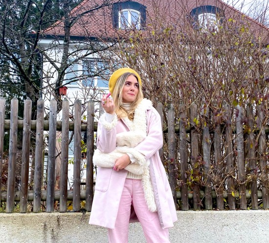 Double Coat. Fashion Blogger Girl by Style Blog Heartfelt Hunt. Girl with blond hair wearing a pink coat, teddy coat, yellow beret, chunky knit vest, faux fur bag, pink denim and white boots.