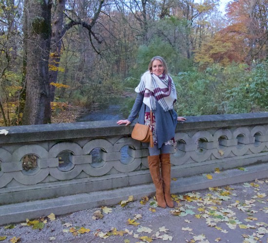 Fall Vibes. Fashion Blogger Girl by Style Blog Heartfelt Hunt. Girl with blond, loose curls wearing a floral dress, poncho, plaid scarf, tassel bag and suede thigh high boots.