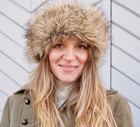 Faux Fur Hat. Fashion Blogger Girl by Style Blog Heartfelt Hunt. Girl with blond, long hair wearing a faux fur hat, coat, bag, pompoms and Ugg boots.