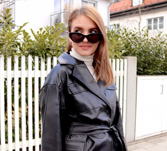 Faux Leather Blazer. Fashion Blogger Girl by Style Blog Heartfelt Hunt. Girl with blond hair showing a faux leather blazer, white turtleneck, mom jeans, slim sunglasses, 90s bag and chunky chelsea boots.