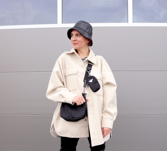 Faux Leather Look. Fashion Blogger Girl by Style Blog Heartfelt Hunt. Girl with blond braid wearing a faux leather bucket hat, shacket, striped tee, faux leather pants, 90s bag and faux leather combat boots.