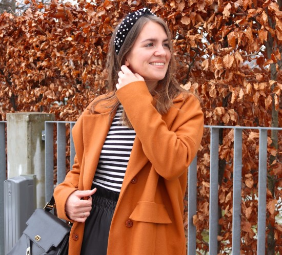 Faux Leather Pants. Fashion Blogger Girl by Style Blog Heartfelt Hunt. Girl with blond hair and pearl headband wearing faux leather pants, striped turtleneck sweater, coat, vintage MCM bag and sock boots.