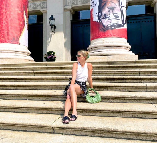 Floral Mini Skirt. Fashion Blogger Girl by Style Blog Heartfelt Hunt. Girl with blond hair and green hair claw clip wearing a floral mini skirt, DIY summer top, green sunglasses, green ruched bag and padded sandals.