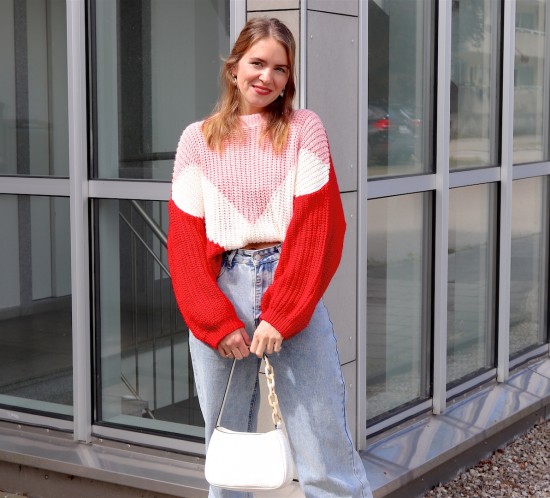 Geometric Pattern Sweater. Fashion Blogger Girl by Style Blog Heartfelt Hunt. Girl with blond half-up half-down hairstyle with scrunchie wearing a geometric pattern sweater, wide leg jeans, white 90s bag and red mules.