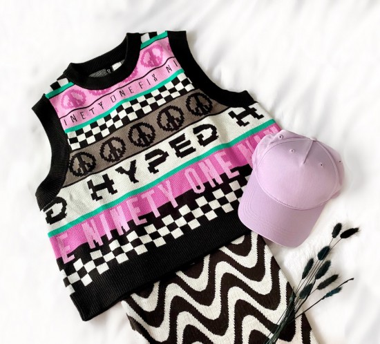 HM Try-On Haul. Fashion Blogger Girl by Style Blog Heartfelt Hunt. Girl with blond hair wearing a floral dress, pink blouse, zigzag pants, gray leggings, floral blouse, floral pants, knit vest and pink dress.