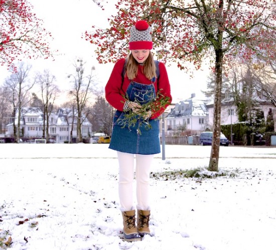 Mistletoe. Fashion Blogger Girl by Style Blog Heartfelt Hunt. Girl with blond pigtails wearing a red chunky sweater, striped turtleneck top, denim dress, leggings, beanie with pompom, Rebecca Minkoff backpack and Sorel boots.