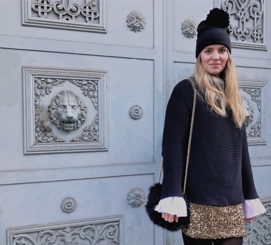 New Year’s Eve 2016. Fashion Blogger Girl by Style Blog Heartfelt Hunt. Girl with blond loose curls wearing a heavy knit sweater, blouse with trumpet sleeves, golden sequin dress, pompom beanie, faux fur bag and boots.
