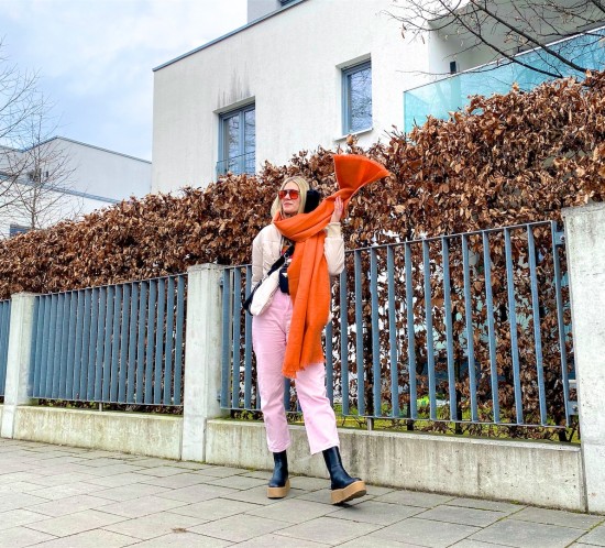 Orange Details. Fashion Blogger Girl by Style Blog Heartfelt Hunt. Girl with blond hair wearing puffer jacket, striped sweater, pink denim, orange scarf, orange sunglasses, 90s bag and chunky chelsea boots.