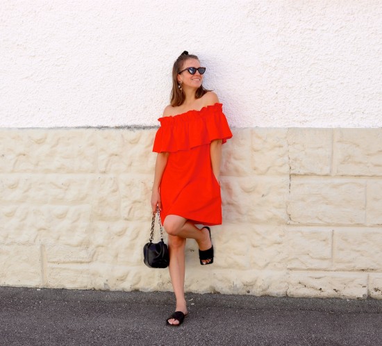 Orange Summer Dress. Fashion Blogger Girl by Style Blog Heartfelt Hunt. Girl with blond half-up half-down hairstyle bun wearing an orange summer dress, slim cat-eye sunglasses, pouch bag and sandals.