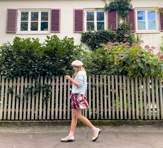 Pastel For Fall. Fashion Blogger Girl by Style Blog Heartfelt Hunt. Girl with blond hair wearing a mint pastel sweater, pastel pink beret, floral dress, pink Staud bag and off-white loafers.
