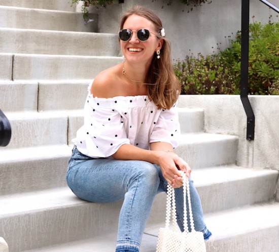 Pearl Bag. Fashion Blogger Girl by Style Blog Heartfelt Hunt. Girl with blond hair and pearl hair clip wearing a pearl bag, polka dot top, mom jeans, pearl earrings, Ray-Ban sunglasses and chunky sneakers.