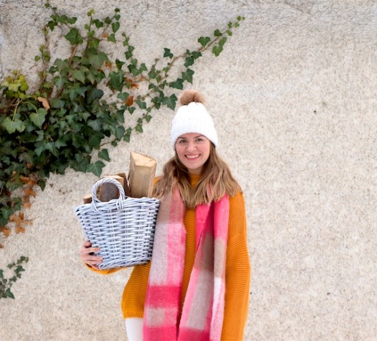 Pink Checked Scarf. Fashion Blogger Girl by Style Blog Heartfelt Hunt. Girl with blond hair wearing a pink checked scarf, yellow sweater, off-white corduroy pants, beanie with faux fur pompom and Sorel boots.