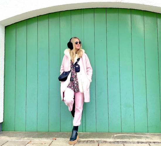 Pink Coat. Fashion Blogger Girl by Style Blog Heartfelt Hunt. Girl with blond hair wearing a pink coat, Ray-Ban sunglasses, 90s bag, floral dress, pink denim and chelsea boots.