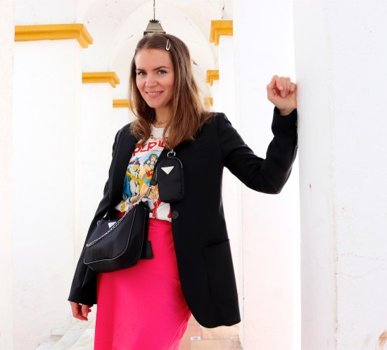 Pink Skirt. Fashion Blogger Girl by Style Blog Heartfelt Hunt. Girl with blond hair wearing a blazer, graphic tee, statement necklace, pink skirt, bag and chunky sneakers.