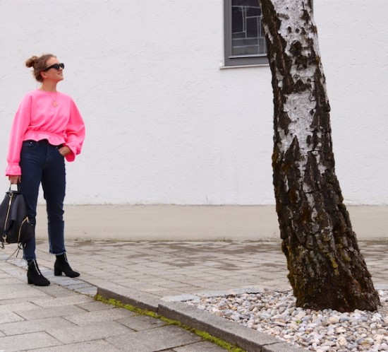Pink Sweater. Fashion Blogger Girl by Style Blog Heartfelt Hunt. Girl with blond, high, messy bun wearing a pink sweater, mom jeans, slim sunglasses, Rebecca Minkoff backpack and sock boots.