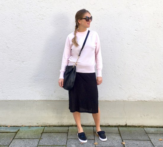 Pink Sweater. Fashion Blogger Girl by Style Blog Heartfelt Hunt. Girl with blond dutch braid wearing a black dress, pink sweater, Michael Kors bag, cat eye sunglasses and mule sneakers with a bow.