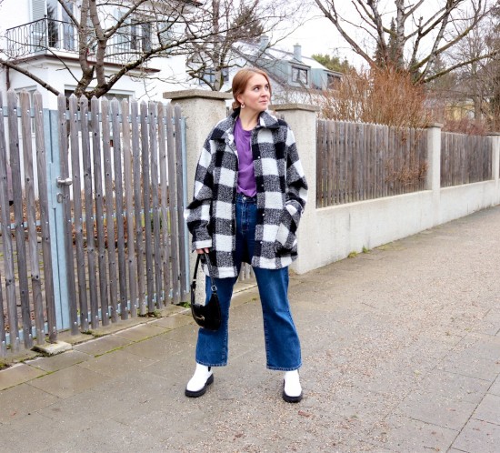 Plaid & Purple. Fashion Blogger Girl by Style Blog Heartfelt Hunt. Girl with blond low bun wearing a plaid jacket, purple tee, wide leg jeans, slim sunglasses, 90s bag and white boots.