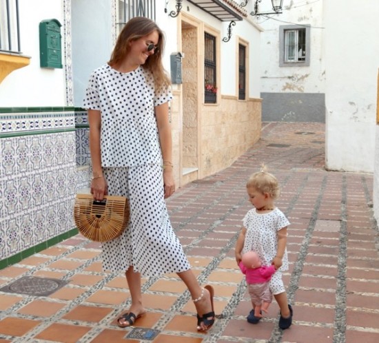 Polka Dot Trouble. Fashion and Style Blog Girl from Heartfelt Hunt. Girl with blonde hair wearing a polka dot top, polka dot pants, Ray-Ban sunglasses, bamboo bag and black sandals. She and her little mini me wearing matching mother daughter outfits with polka dot two pieces.