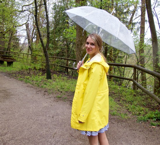 Rainy Days. Fashion Blogger Girl by Style Blog Heartfelt Hunt. Girl wearing a yellow raincoat, striped dress and an umbrella.