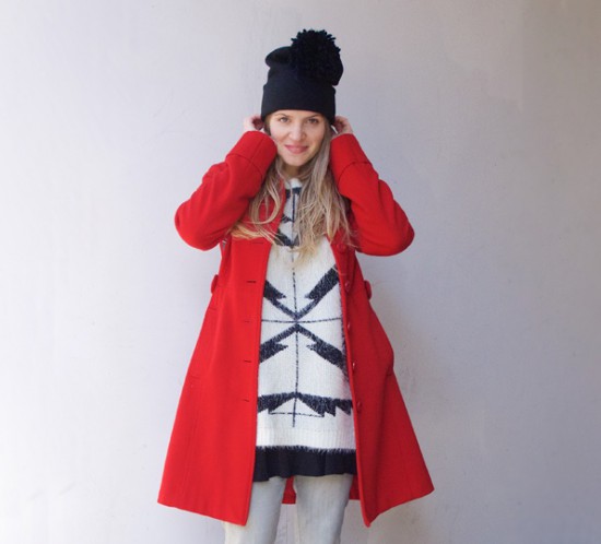 Red Coat. Fashion Blogger Girl by Style Blog Heartfelt Hunt. Girl with blond, long hair wearing a red coat, black and white oversized sweater, diy fringe jeans, dress, diy pompom beanie and boots.