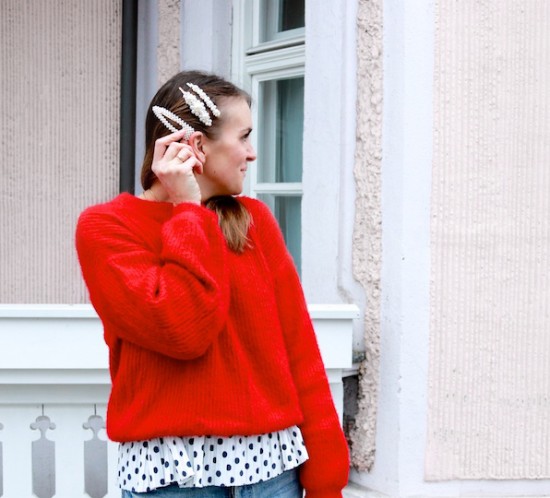 Red Polka Dots. Fashion Blogger Girl by Style Blog Heartfelt Hunt. Girl with blond hair and pearl hair clips wearing a red sweater, polka dot top, mom jeans, pearl bag and glossy boots.