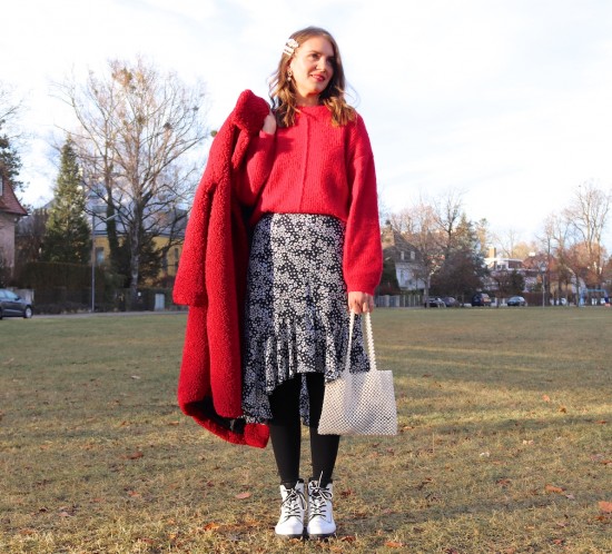 Red Teddy Coat. Fashion Blogger Girl by Style Blog Heartfelt Hunt. Girl with blond, loose curls wearing a red teddy coat, red sweater, floral midi skirt, pearl hair clips, pearl bag and white boots.