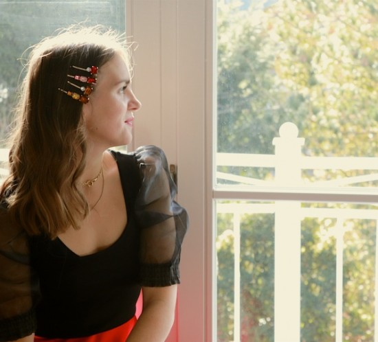 Rhinestone Hair Clips. Fashion Blogger Girl by Style Blog Heartfelt Hunt. Girl with blond hair and rhinestone hair clips wearing a black transparent blouse and red satin skirt.