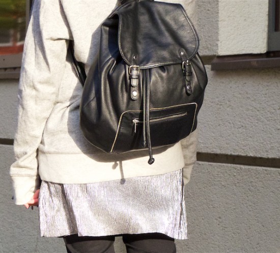 Silver Slip Dress. Fashion Blogger Girl by Style Blog Heartfelt Hunt. Girl with blond high messy bun wearing a silver slip dress, oversized sweater, jeans, backpack and burgundy brogues.