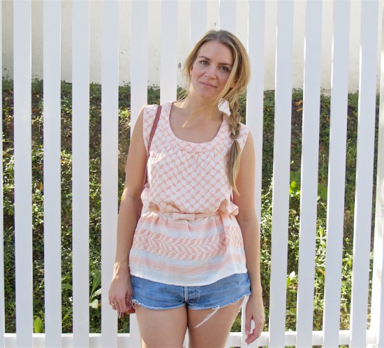 Summer Pink. Fashion Blogger Girl by Style Blog Heartfelt Hunt. Girl with blond side braid wearing a summer pink top, denim shorts, pink bow belt, pink suede bag and metallic sandals.
