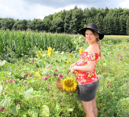 Sunflower Fields. Fashion Blogger Girl by Style Blog Heartfelt Hunt. Girl with blond side braid wearing a floral off-shoulder dress, skirt, floppy hat and boots.