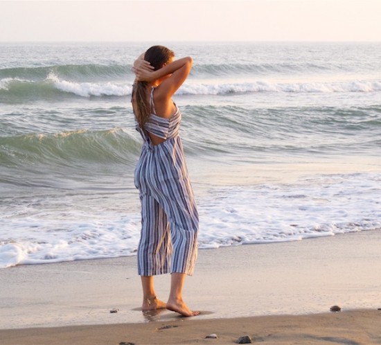 Sunset On The Beach. Fashion Blogger Girl by Style Blog Heartfelt Hunt. Girl with blond, long hair wearing a striped jumpsuit for a sunset on the beach.