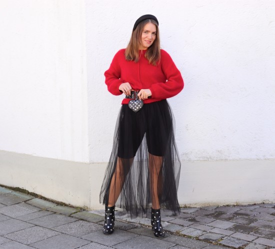 Valentines Tulle. Fashion Blogger Girl by Style Blog Heartfelt Hunt. Girl with blond hair and padded headband a red sweater, tulle skirt, padded headband, studded belt, studded heart bag and studded boots.