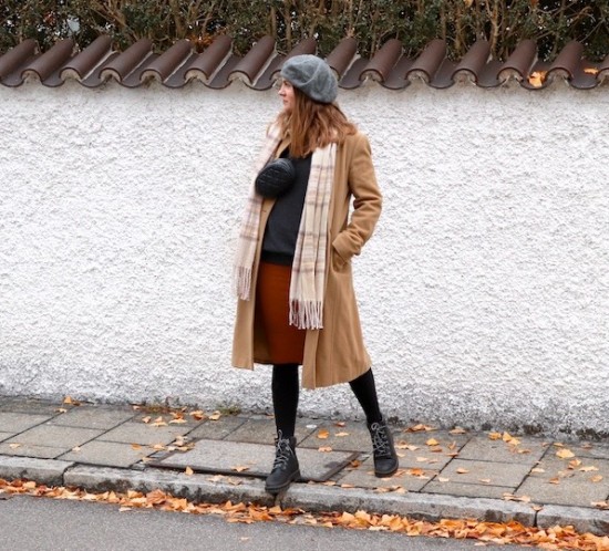 Winter Layering. Fashion Blogger Girl by Style Blog Heartfelt Hunt. Girl with blond hair wearing a camel coat, turtleneck sweater, knit dress, beret, checked scarf, belt bag and Timberland boots.