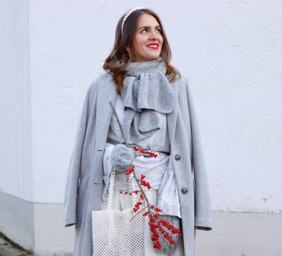 Winter Whites. Fashion Blogger Girl by Style Blog Heartfelt Hunt. Girl with blond, loose curls wearing a coat, sweater with trumpet sleeves, tulle skirt, pearl headband, pearl bag, mittens and faux fur booties.