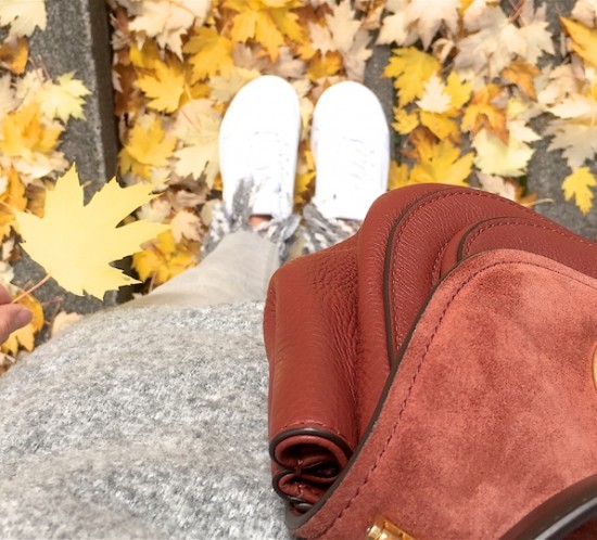 Yellow Fall. Fashion Blogger Girl by Style Blog Heartfelt Hunt. Girl with blond ponytail wearing a Sweater, striped blouse, fringe jeans, sunglasses, Michael Kors bag, belt with flowers and chunky sneakers.