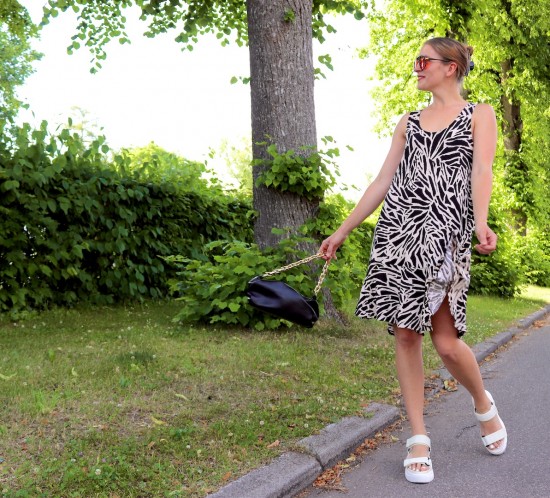 Zebra Print Dress. Fashion Blogger Girl by Style Blog Heartfelt Hunt. Girl with blond hair wearing a zebra print dress, orange sunglasses, black pouch bag and chunky sandals.